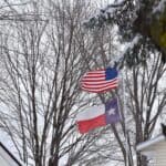 USA and Texas flags in the wind and snow
